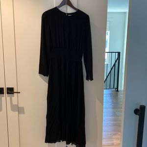 Wilfred long black dress with a cinched in elastic waist and see through arms
